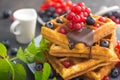 Sweet dessert belgian waffles with chocolate, blueberry and red currant