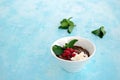 Sweet dessert, chocolate pudding in white portioned saucers on a light blue background. Served with whipped cream and red currant Royalty Free Stock Photo