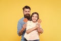 Sweet dessert concept. Bearded hipster good daddy for adorable daughter. Daughter and father eat sweet candies. Sweet