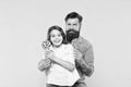Sweet dessert concept. Bearded hipster good daddy for adorable daughter. Daughter and father eat sweet candies. Sweet