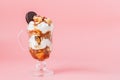 Sweet dessert in glass with biscuit and whipped cream on pink bsckground, selective focus and blank space