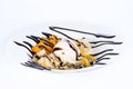 Sweet dessert: ice cream with fruit and chocolate topping on white background