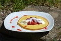 Sweet dessert pancake with strawberries and whipped cream. Royalty Free Stock Photo