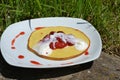 Sweet dessert - Pancakes with strawberries and cream on white plate Royalty Free Stock Photo