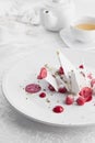 Sweet dessert white cake with raspberries, in a restaurant on the table. Photo of food on a light background