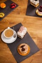 Sweet desserts on a wooden table in a coffee shop near tasty cup of coffee Royalty Free Stock Photo