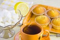 Sweet domestic cakes, tea, lemon and vase with sugar