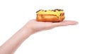 Hand with sweet donut with icing and chocolate drops, isolated on white background