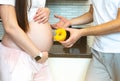 Sweet donut and pregnant woman. Healthy food during pregnancy Royalty Free Stock Photo