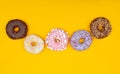 Sweet chocolate donuts on yellow background. Dessert food.