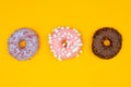 Sweet donuts on yellow background. Dessert food.