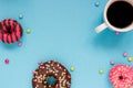 Sweet donuts with coffee on the blue background.