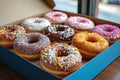 Sweet Donuts Enrobed in Vivid Colorful Icing in a Blue Box. AI Generated