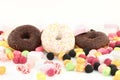 Sweet donuts, many bright candies and marshmallows