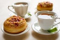 Sweet donuts on plates and cups with mint tea on the wooden table. Royalty Free Stock Photo