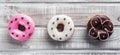 Sweet donuts, on white wooden table, placed in the center. Selective focus, top view