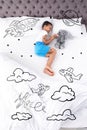 Sweet dreams. Cute African American boy sleeping. Spaceship, stars and planet illustrations on foreground Royalty Free Stock Photo