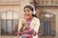 Sweet dreams. healthy food. child has music break. girl in headphones. little girl in wireless headset with lollipop Royalty Free Stock Photo