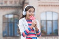 Sweet dreams. healthy food. child has music break. girl in headphones. little girl in wireless headset with lollipop Royalty Free Stock Photo