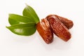 Sweet dried dates fruit on green leaf, mediterranean desert isol