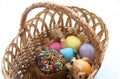 Sweet Easter cake with colorful eggs in a wicker basket isolated on white background Royalty Free Stock Photo