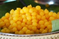 Sweet egg yolk fudge balls cooked in syrup in banana leaf