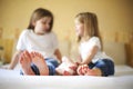 Sweet family in bed. Three sisters, close up on feet