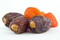 sweet figs and dried apricots on white background
