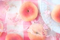 Sweet flat peaches on a pink tablecloth, cute delicious Asian fruit taken close-up