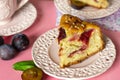 Sweet fluffy cake with fresh plums and hazelnuts Royalty Free Stock Photo