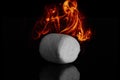 Sweet fluffy marshmallows isolated on black glass