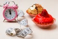 Sweet food measuring tape and clock on table