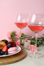 Sweet food, wine and flowers against pink background Royalty Free Stock Photo