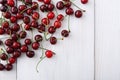 Sweet fresh cherries on white wood background