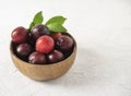 Sweet fresh delicious red plums on bowl white wood table summer fruits