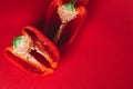 SWEET, fresh RED PEPPER ON A RED BACKGROUND, cut in half. photo for the menu, proper nutrition. fresh vegetables