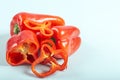 Sweet fresh red peppers on light blue background Royalty Free Stock Photo