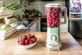 Sweet fresh strawberry cocktail in vintage retro blender on the kitchen table Royalty Free Stock Photo