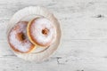 Sweet fried donut covered with sugar on plate