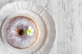 Sweet fried donut covered with sugar on plate