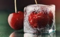 Sweet frozen delicious red cherry in ice on green table macro ba Royalty Free Stock Photo