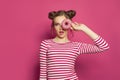 Sweet funny model woman with colorful donut on bright pink background