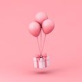 Sweet gift box flying with pink pastel color balloons isolated on light pink background