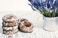 Sweet gingerbread cookies in white glaze, in an aluminum mug a bouquet of lavender flowers