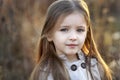 Sweet girl in a cap with the deer in autumn in a field of dry grass Royalty Free Stock Photo