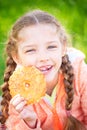 Sweet girl with a fallen toth holding cookies in her hand Royalty Free Stock Photo