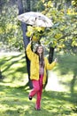 Sweet girl jumping with umbrella Royalty Free Stock Photo