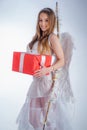 Sweet girl wearing angel costume white dress and feather wings. Valentine Day Gift Card - Holiday teen Cupid with Love