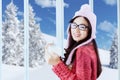 Sweet girl in winter clothes holding hot coffee Royalty Free Stock Photo