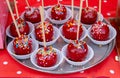 Sweet glazed red toffee candy apples on sticks for sale on farmer market or country fair. Thanksgiving and Halloween homemade red Royalty Free Stock Photo